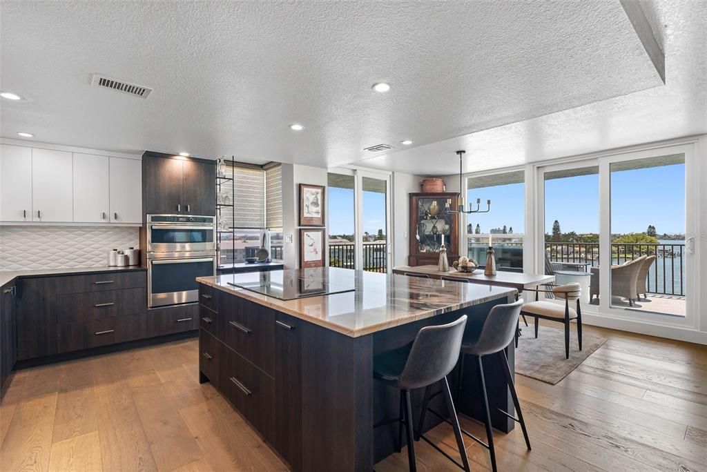 Dining room, Interior, Kitchen, Pendant Lights, Recessed Lighting, Stainless Steel Appliances, Water, Wood Texture Flooring
