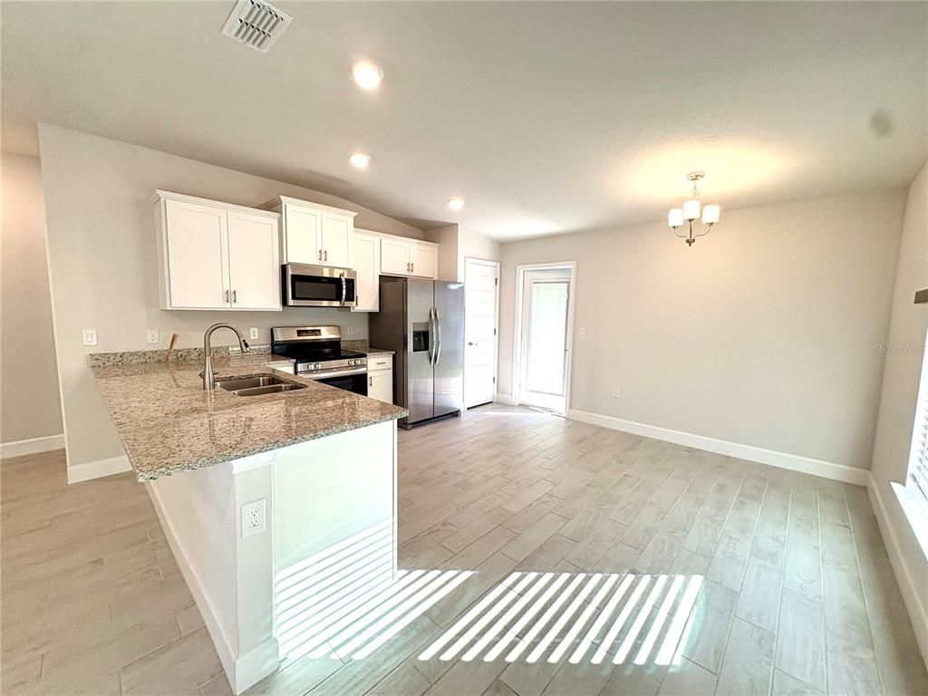 Chandelier, Interior, Kitchen, Recessed Lighting, Stainless Steel Appliances, Wood Texture Flooring