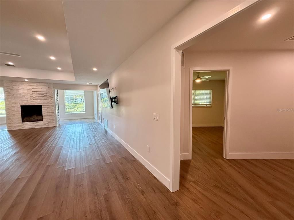 Empty room, Fireplace, Interior, Recessed Lighting, Stone Walls, Wood Texture Flooring
