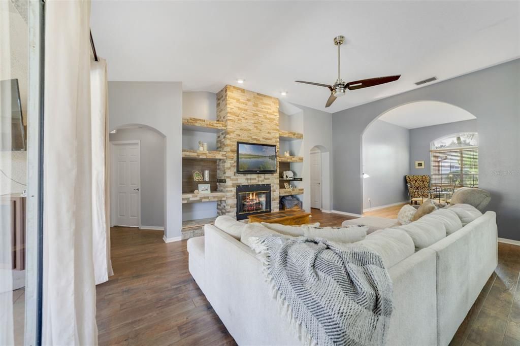 Fireplace, Interior, Living room, Recessed Lighting, Stone Walls, Wood Texture Flooring