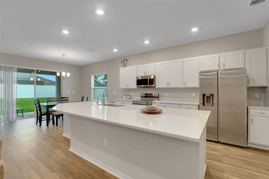 Chandelier, Dining room, Interior, Kitchen, Pendant Lights, Recessed Lighting, Stainless Steel Appliances, Wood Texture Flooring