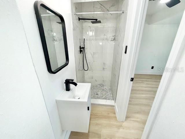 Bathroom, Glass Shower, Interior, Marble Walls, Wood Texture Flooring