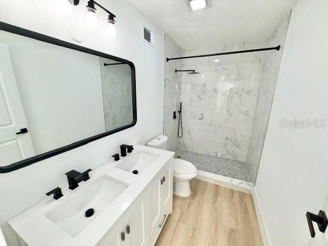 Bathroom, Dual Sink Vanities, Glass Shower, Interior, Marble Walls, Wood Texture Flooring
