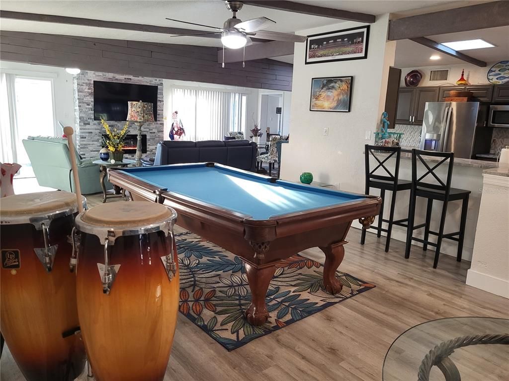 Billiard Table, Fireplace, Game Room, Interior, Kitchen, Recessed Lighting, Stainless Steel Appliances, Stone Walls, Wood Texture Flooring