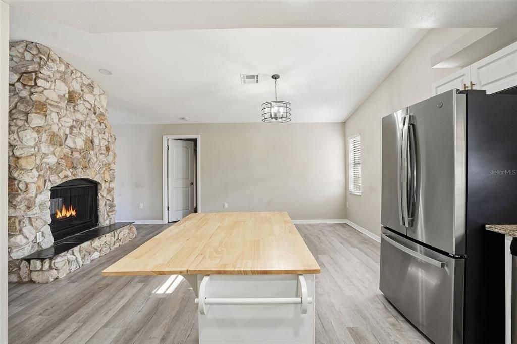 Dining room, Fireplace, Interior, Kitchen, Pendant Lights, Stone Walls, Wood Texture Flooring