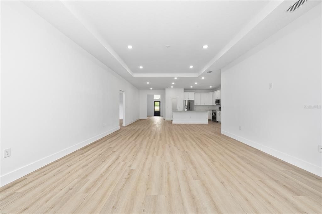 Empty room, Interior, Kitchen, Recessed Lighting, Stainless Steel Appliances, Wood Texture Flooring