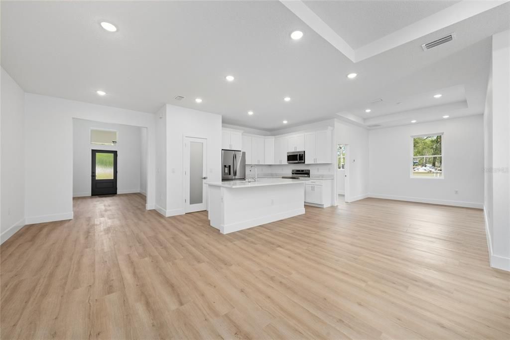 Empty room, Interior, Kitchen, Recessed Lighting, Stainless Steel Appliances, Wood Texture Flooring