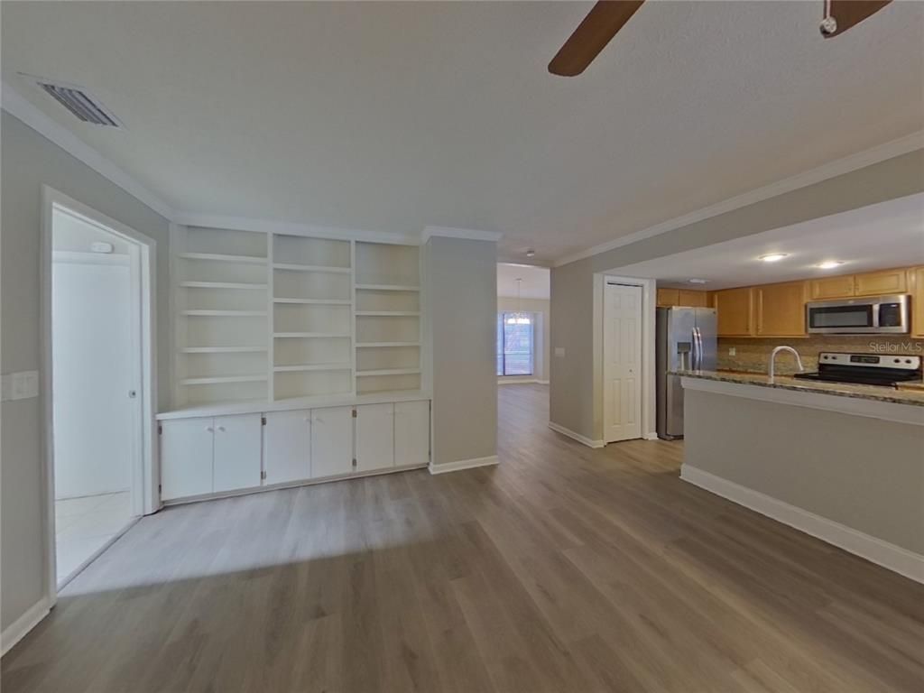 Empty room, Interior, Kitchen, Recessed Lighting, Stainless Steel Appliances, Wood Texture Flooring
