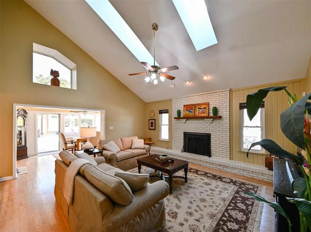 Dining room, Fireplace, Interior, Living room, Recessed Lighting, Stone Walls, Wood Texture Flooring