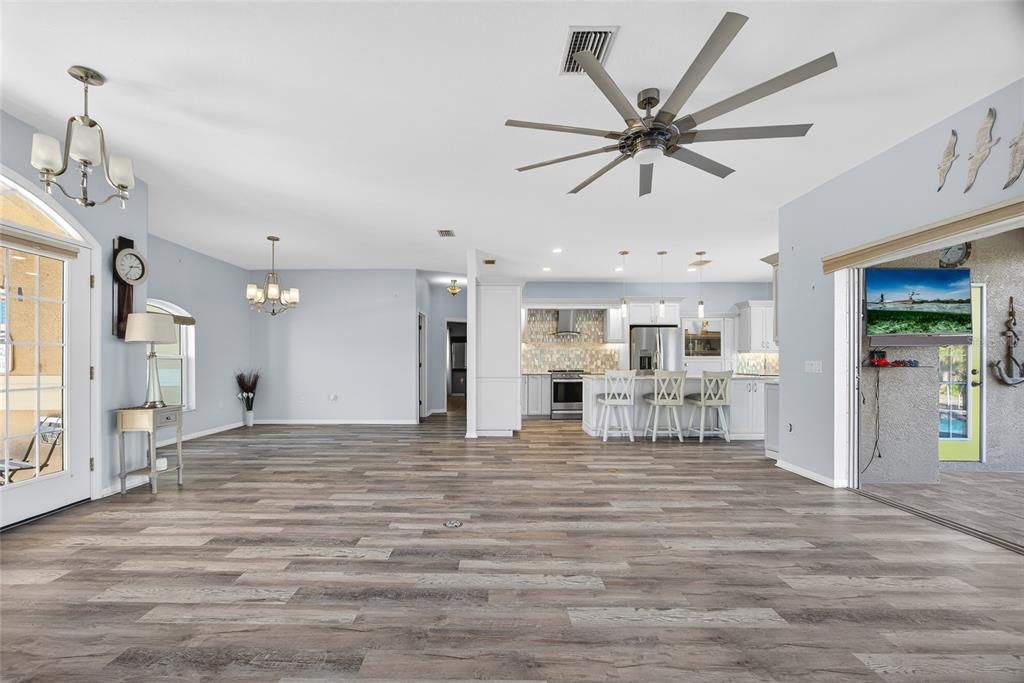 Chandelier, Empty room, Interior, Kitchen, Pendant Lights, Recessed Lighting, Stainless Steel Appliances, Wood Texture Flooring