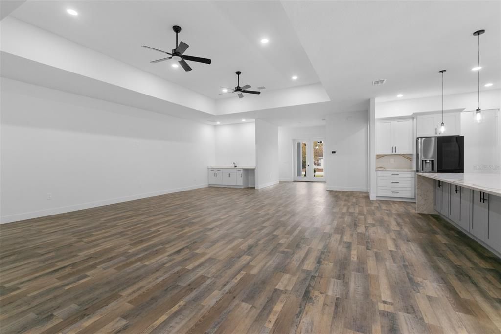 Empty room, Interior, Kitchen, Pendant Lights, Recessed Lighting, Stainless Steel Appliances, Wood Texture Flooring