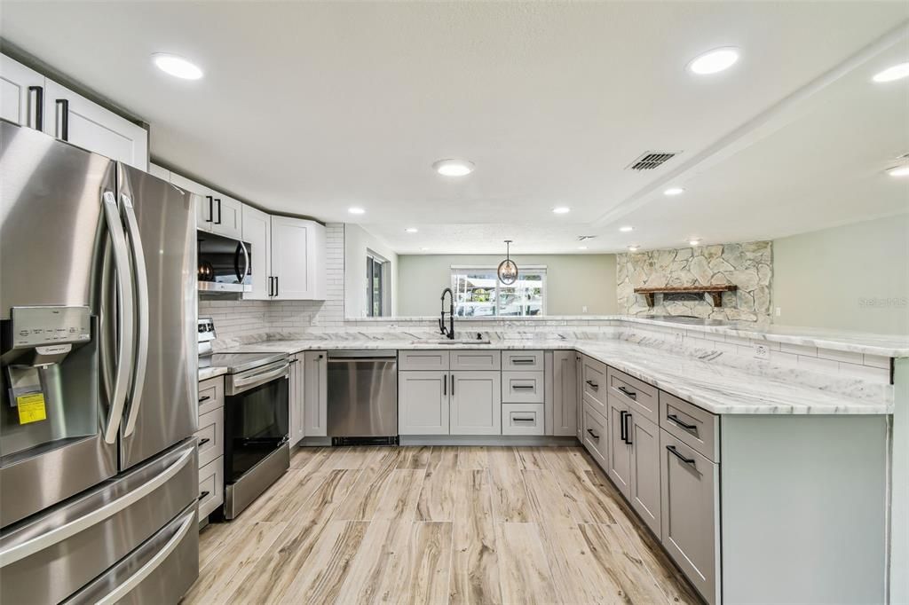 Interior, Kitchen, Recessed Lighting, Stainless Steel Appliances, Stone Walls, Wood Texture Flooring