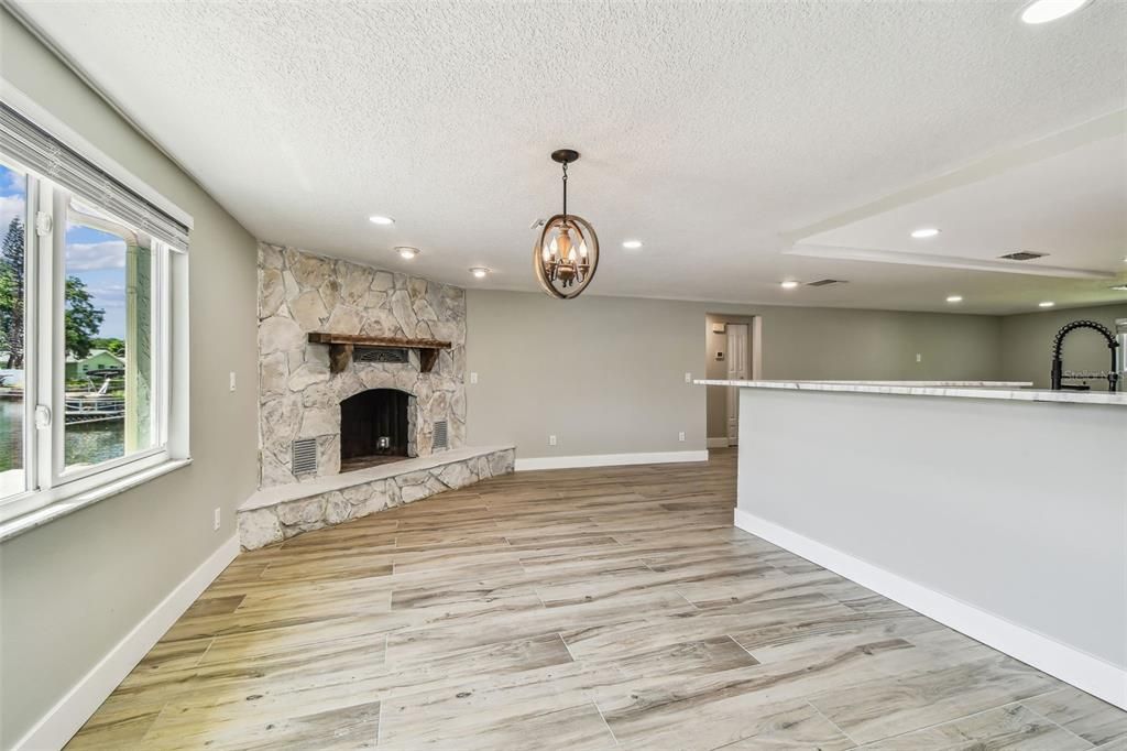 Empty room, Fireplace, Interior, Pendant Lights, Recessed Lighting, Stone Walls, Wood Texture Flooring