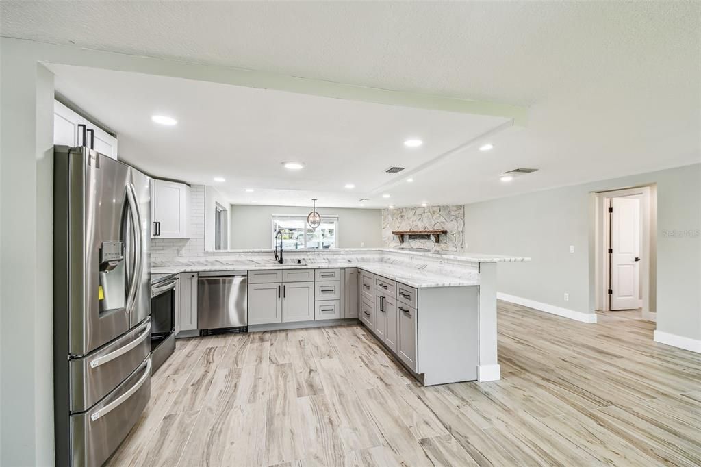 Interior, Kitchen, Marble Walls, Pendant Lights, Recessed Lighting, Stainless Steel Appliances, Wood Texture Flooring