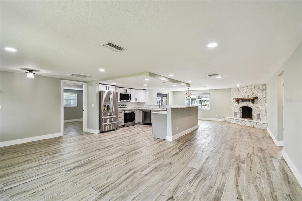 Fireplace, Interior, Kitchen, Recessed Lighting, Stainless Steel Appliances, Wood Texture Flooring