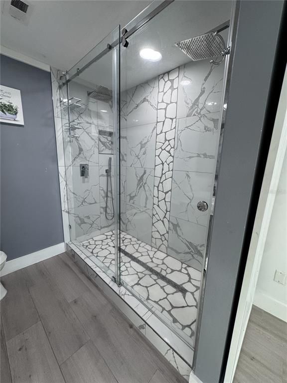 Bathroom, Glass Shower, Interior, Marble Walls, Recessed Lighting, Wood Texture Flooring