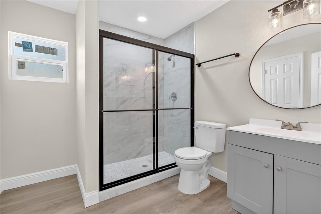 Bathroom, Glass Shower, Interior, Marble Walls, Recessed Lighting, Wood Texture Flooring