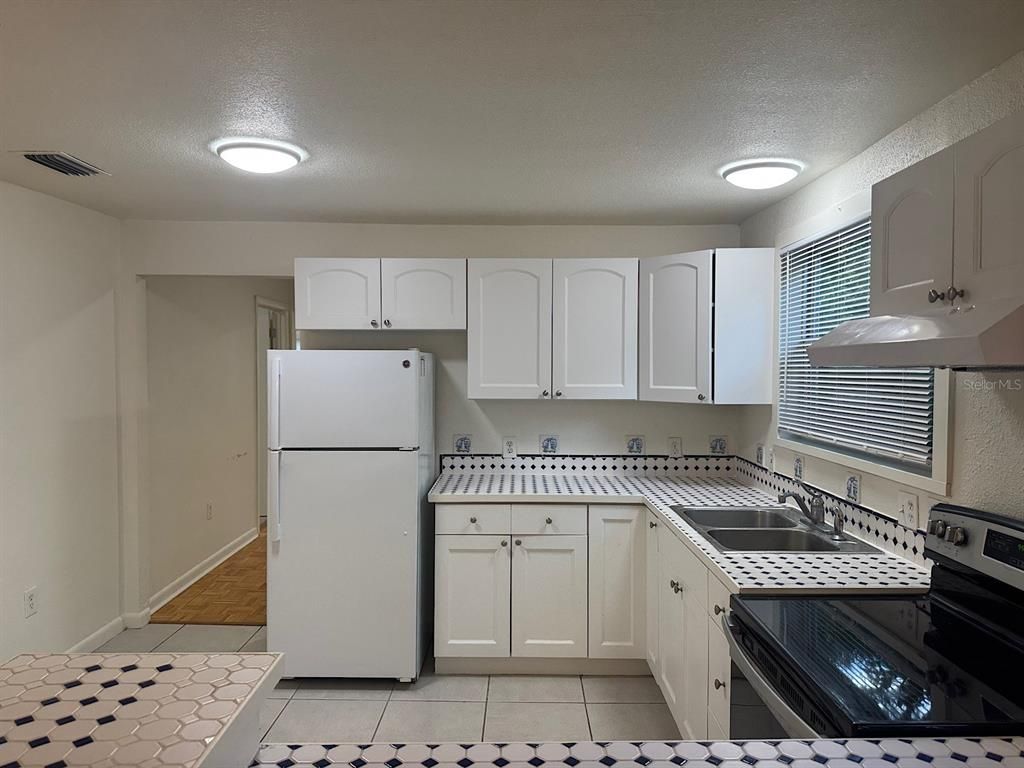 Interior, Kitchen, Recessed Lighting, Tile Countertops, Wood Texture Flooring