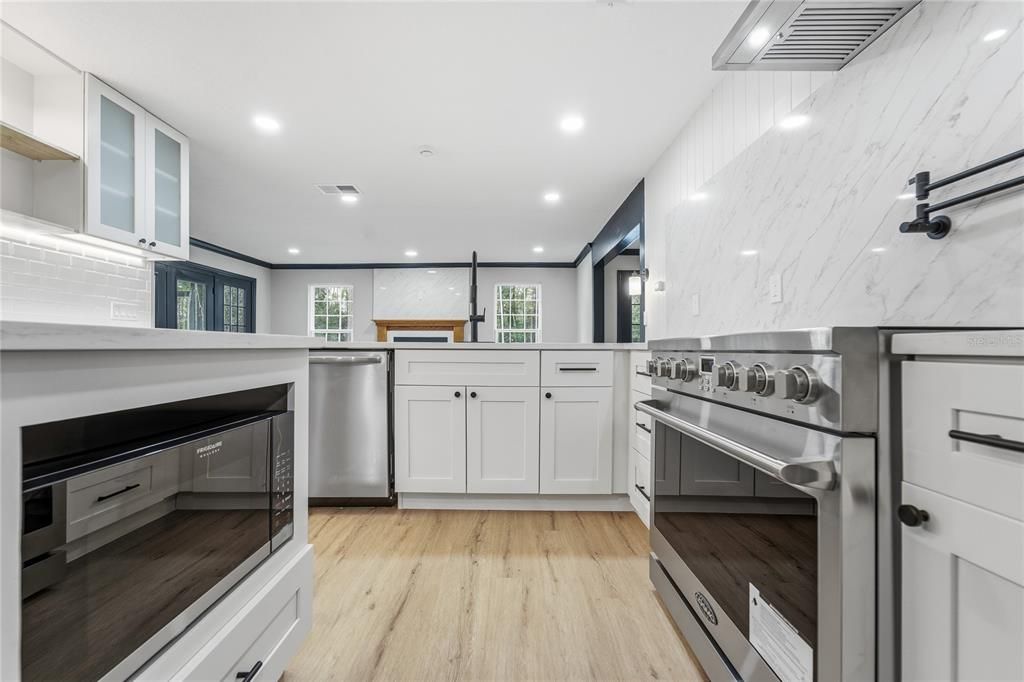 Interior, Kitchen, Marble Walls, Recessed Lighting, Stainless Steel Appliances, Wood Texture Flooring