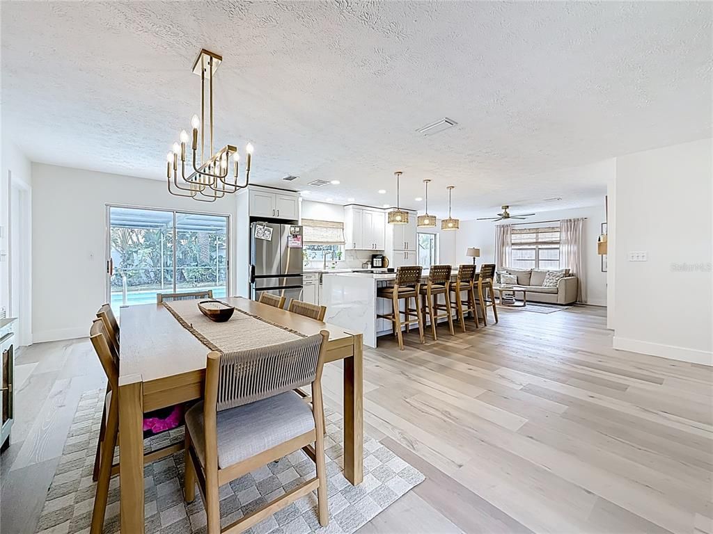 Chandelier, Dining room, Interior, Kitchen, Pendant Lights, Recessed Lighting, Stainless Steel Appliances, Wood Texture Flooring