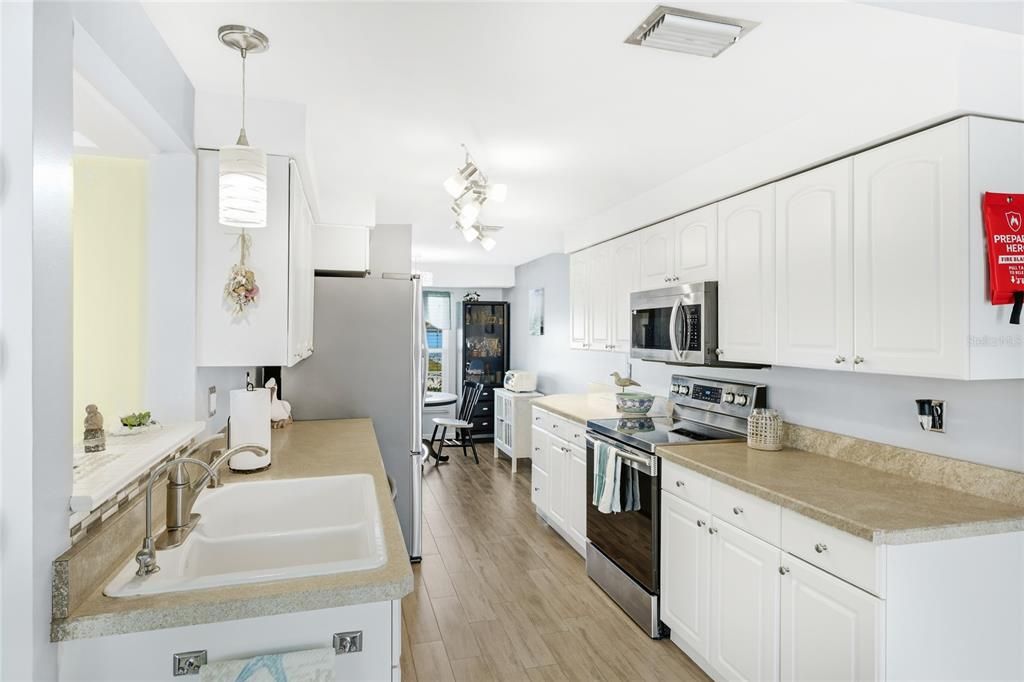 Dining room, Interior, Kitchen, Pendant Lights, Stainless Steel Appliances, Wood Texture Flooring