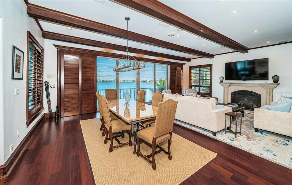 Dining room, Fireplace, Interior, Living room, Pendant Lights, Recessed Lighting, Water, Wooden Beams, Wood Texture Flooring