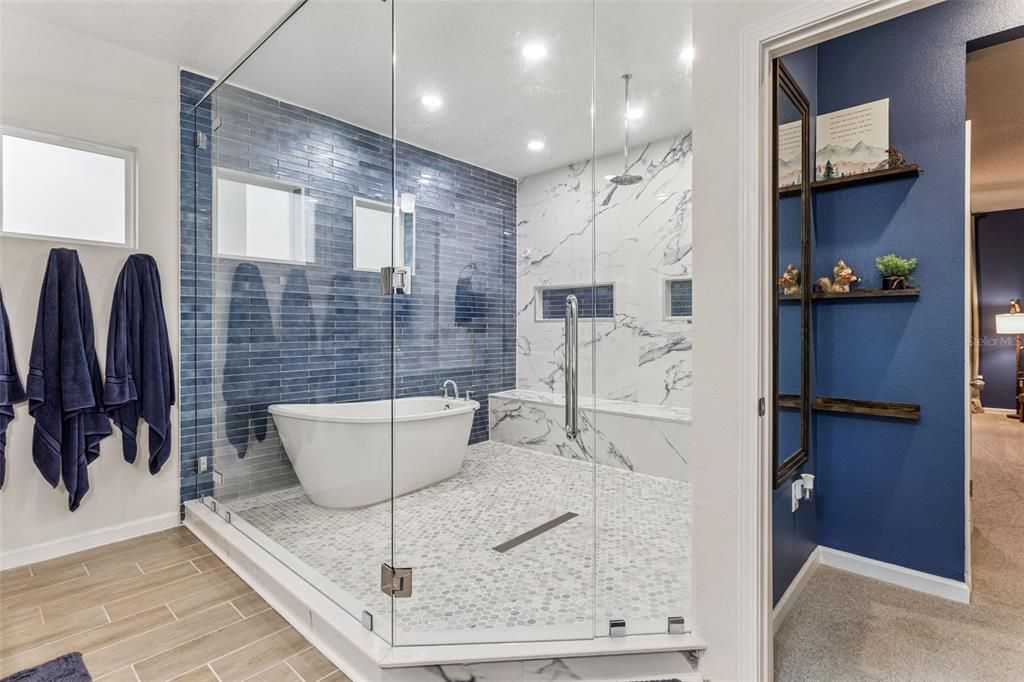 Bathroom, Free Standing Baths, Glass Shower, Interior, Marble Walls, Recessed Lighting, Wood Texture Flooring