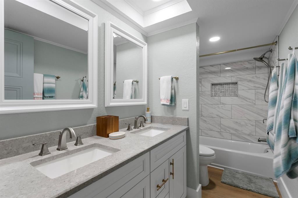 Bathroom, Dual Sink Vanities, Interior, Marble Walls, Recessed Lighting, Wood Texture Flooring