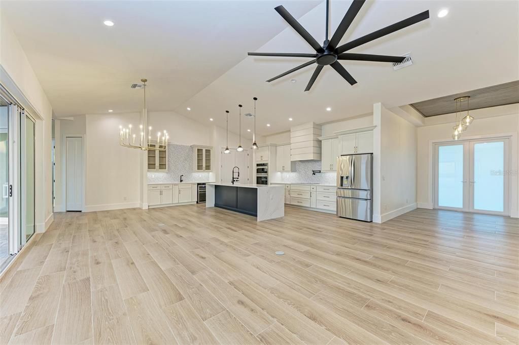 Chandelier, Empty room, Interior, Kitchen, Pendant Lights, Recessed Lighting, Stainless Steel Appliances, Wood Texture Flooring