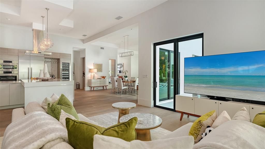 Chandelier, Dining room, Interior, Kitchen, Living room, Pendant Lights, Recessed Lighting, Stainless Steel Appliances, Water, Wood Texture Flooring