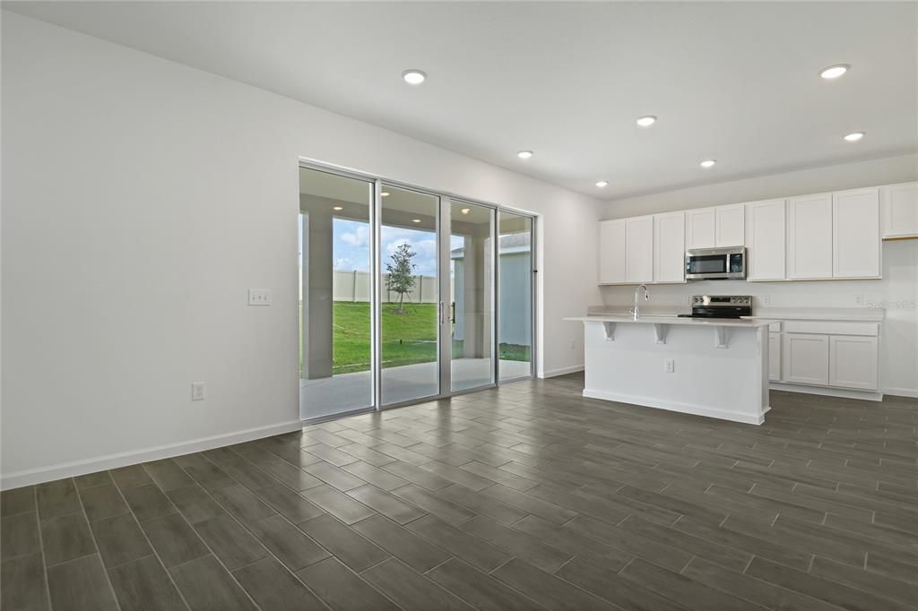 Empty room, Interior, Kitchen, Recessed Lighting, Stainless Steel Appliances, Wood Texture Flooring