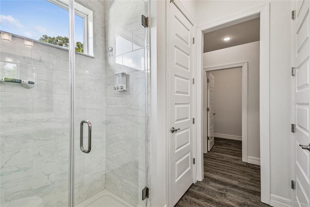 Bathroom, Glass Shower, Interior, Marble Walls, Recessed Lighting, Wood Texture Flooring