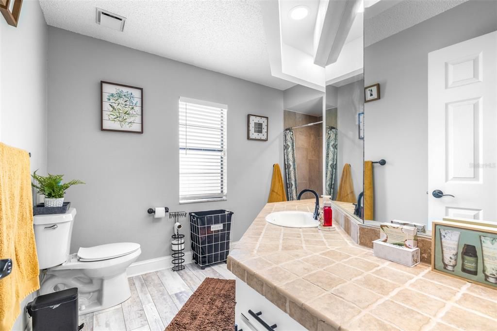 Bathroom, Interior, Recessed Lighting, Tile Countertops, Wood Texture Flooring