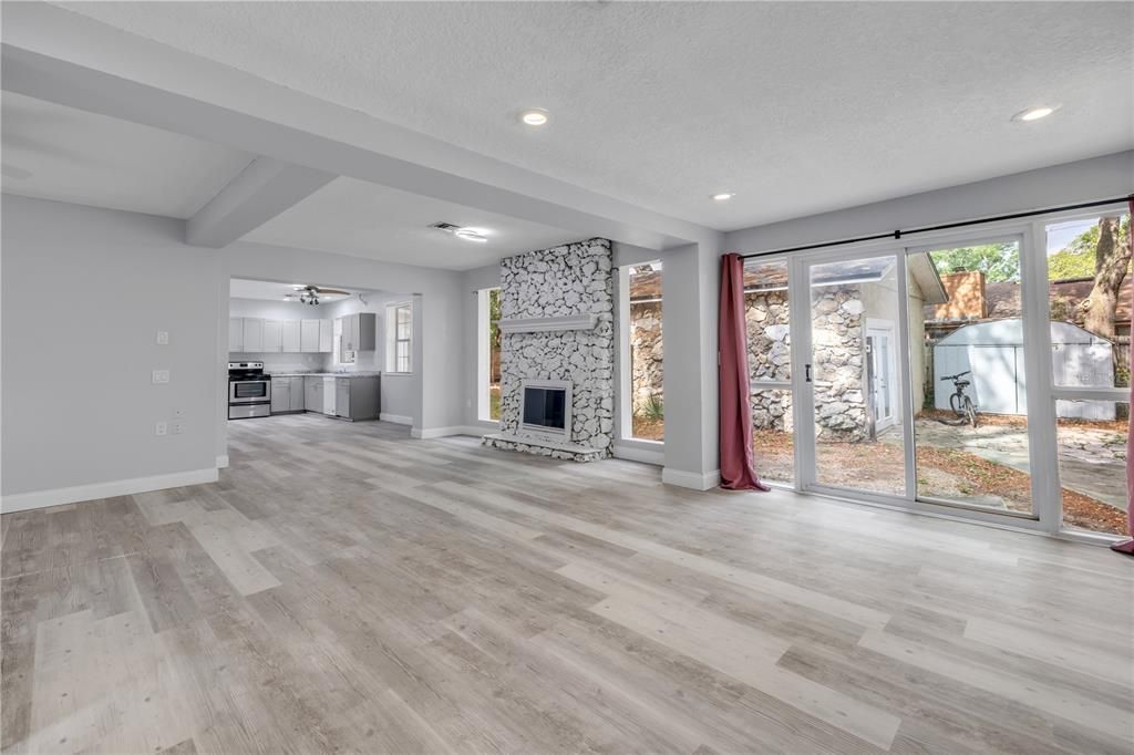 Empty room, Fireplace, Interior, Kitchen, Recessed Lighting, Stone Walls, Wood Texture Flooring