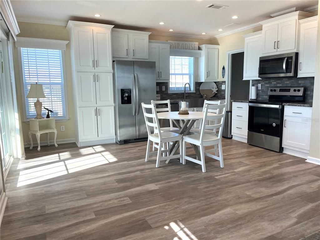 Dining room, Interior, Kitchen, Recessed Lighting, Stainless Steel Appliances, Wood Texture Flooring
