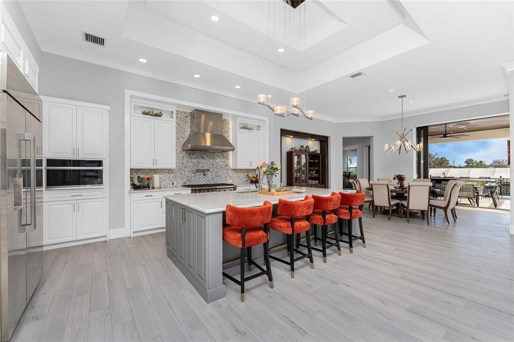 Chandelier, Dining room, Interior, Kitchen, Pendant Lights, Recessed Lighting, Stainless Steel Appliances, Wood Texture Flooring