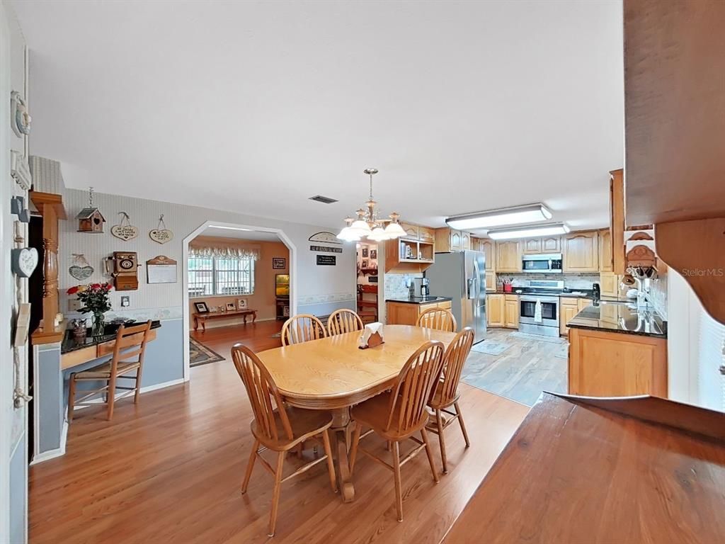 Chandelier, Dining room, Interior, Kitchen, Stainless Steel Appliances, Wood Texture Flooring