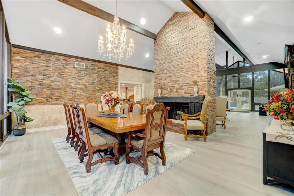 Chandelier, Dining room, Fireplace, Interior, Recessed Lighting, Stone Walls, Wooden Beams, Wood Texture Flooring