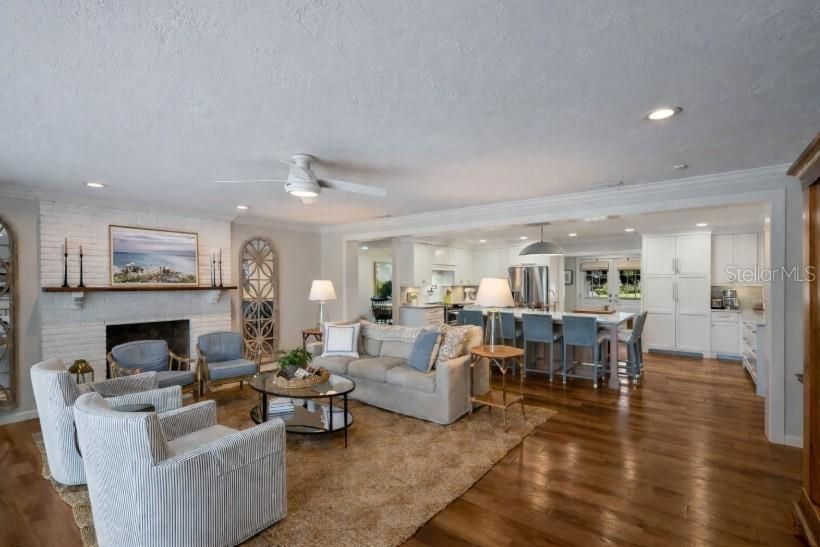 Fireplace, Interior, Kitchen, Living room, Pendant Lights, Recessed Lighting, Stainless Steel Appliances, Stone Walls, Wood Texture Flooring