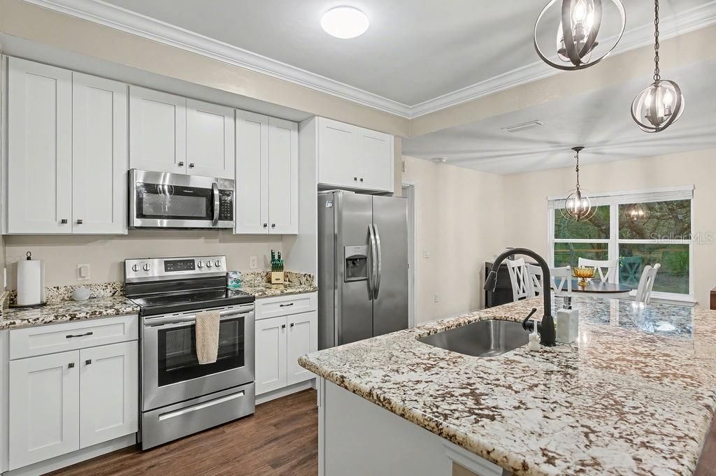 Dining room, Interior, Kitchen, Pendant Lights, Stainless Steel Appliances, Wood Texture Flooring