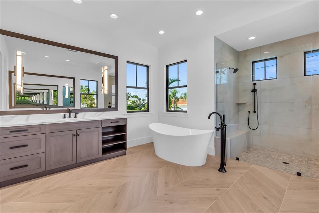 Bathroom, Dual Sink Vanities, Free Standing Baths, Glass Shower, Interior, Marble Walls, Recessed Lighting, Wood Texture Flooring
