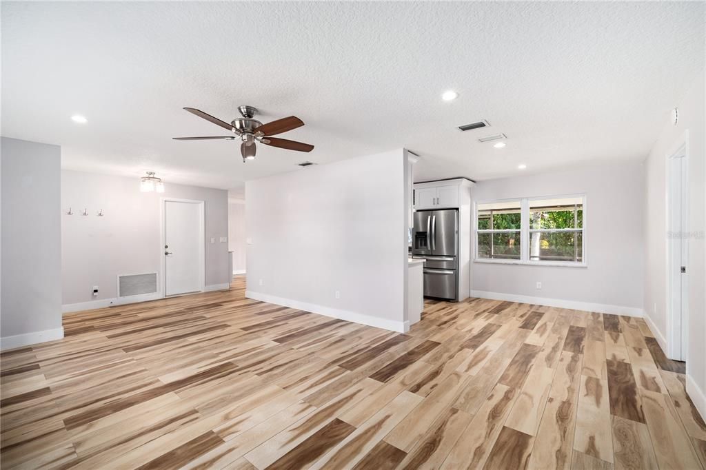 Empty room, Interior, Kitchen, Recessed Lighting, Stainless Steel Appliances, Wood Texture Flooring