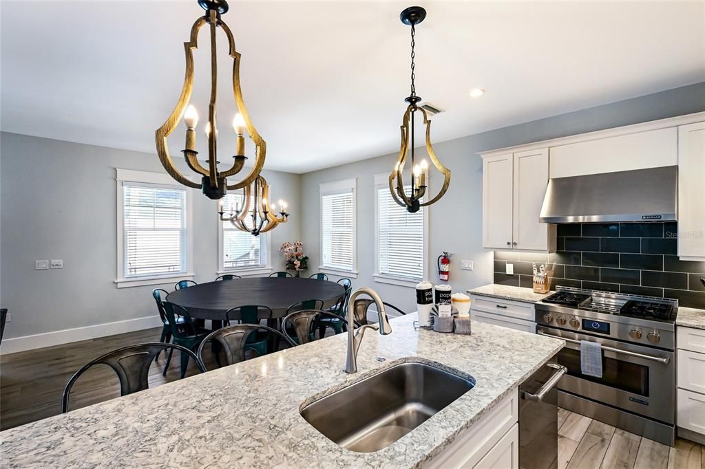 Chandelier, Dining room, Interior, Kitchen, Pendant Lights, Recessed Lighting, Stainless Steel Appliances, Wood Texture Flooring