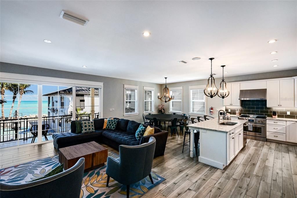 Chandelier, Dining room, Interior, Kitchen, Living room, Pendant Lights, Recessed Lighting, Stainless Steel Appliances, Water, Wood Texture Flooring
