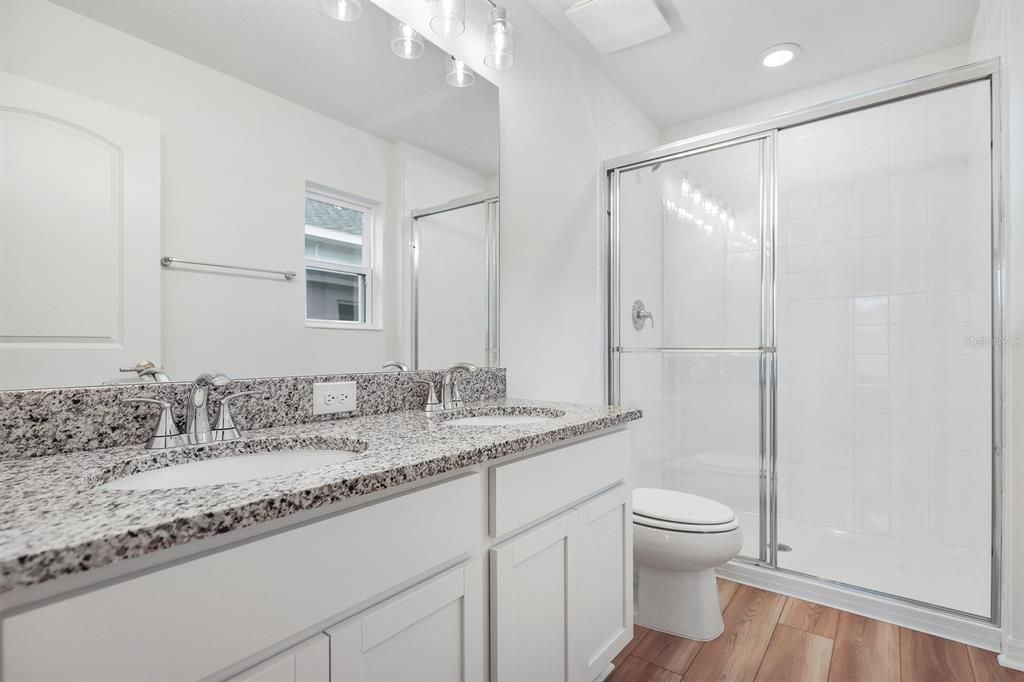 Bathroom, Dual Sink Vanities, Glass Shower, Interior, Recessed Lighting, Wood Texture Flooring