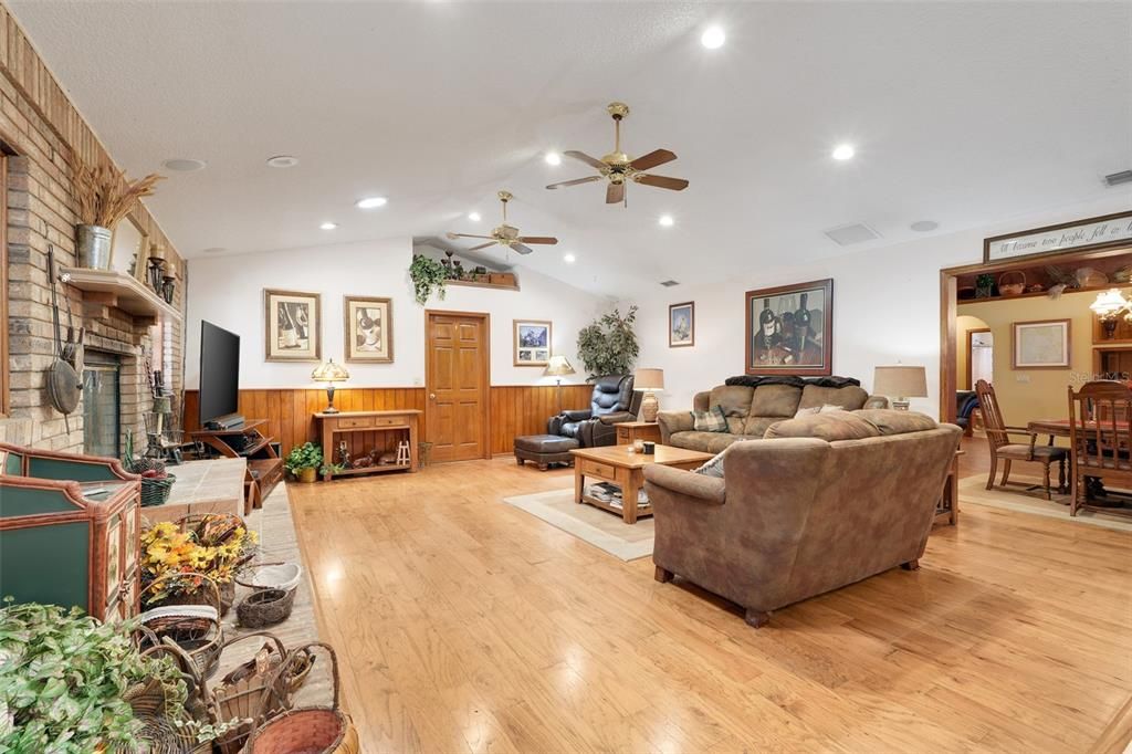 Dining room, Fireplace, Interior, Living room, Recessed Lighting, Stone Walls, Wood Texture Flooring