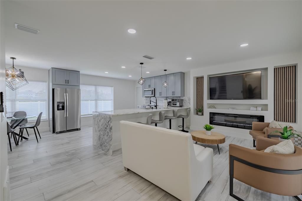 Dining room, Fireplace, Interior, Kitchen, Living room, Pendant Lights, Recessed Lighting, Stainless Steel Appliances, Wood Texture Flooring