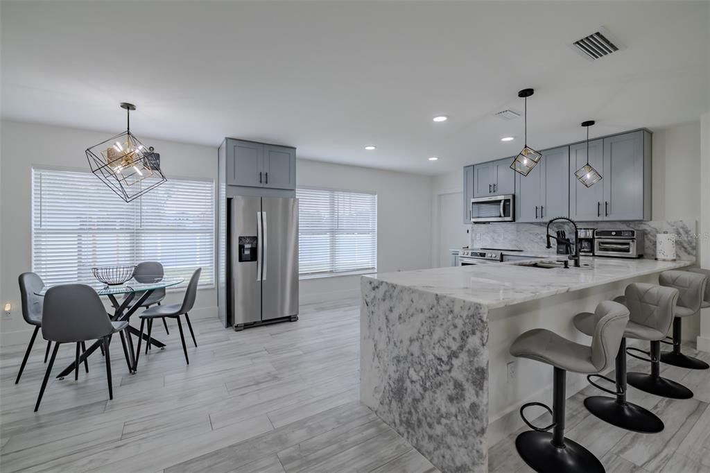 Dining room, Interior, Kitchen, Pendant Lights, Recessed Lighting, Stainless Steel Appliances, Wood Texture Flooring