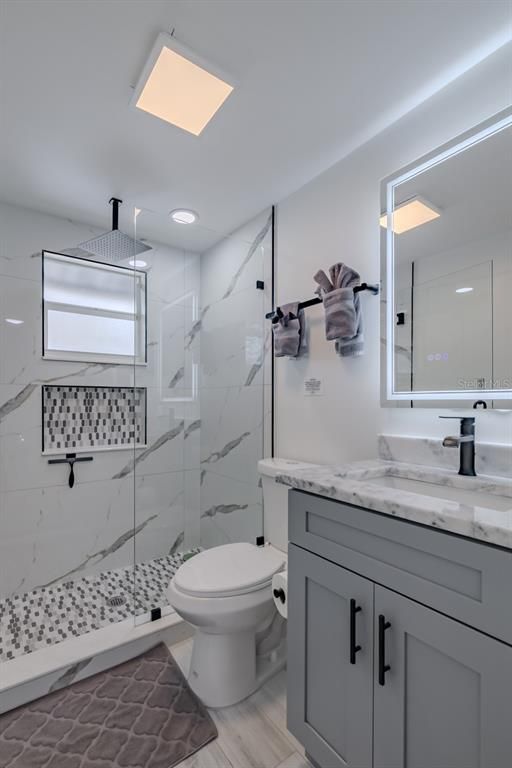 Bathroom, Glass Shower, Interior, Marble Walls, Recessed Lighting, Wood Texture Flooring