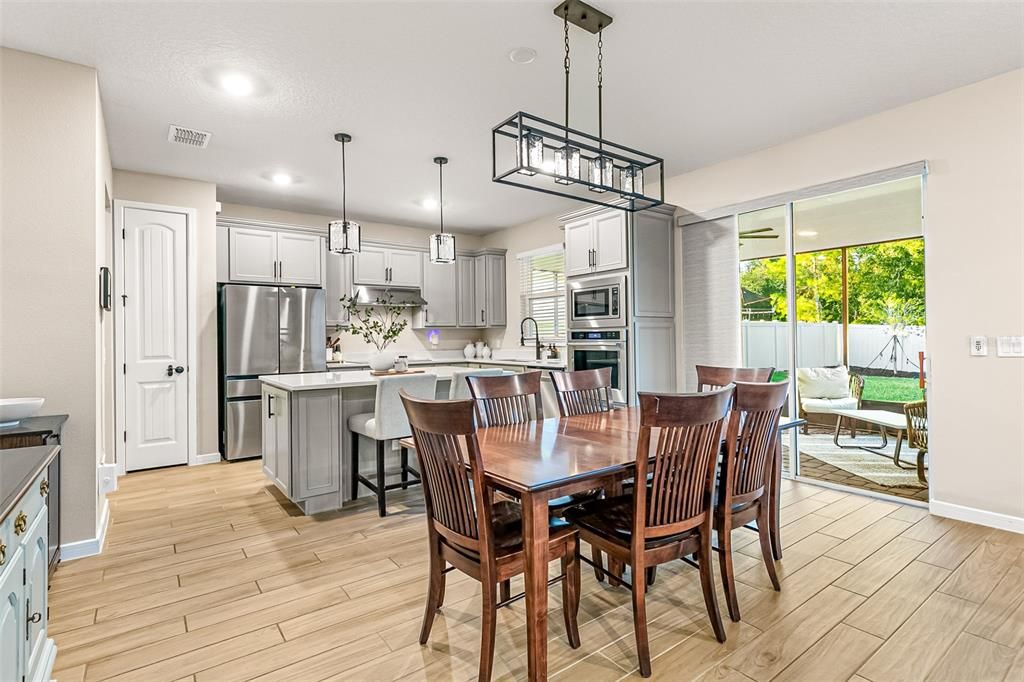Dining room, Interior, Kitchen, Pendant Lights, Recessed Lighting, Stainless Steel Appliances, Wood Texture Flooring